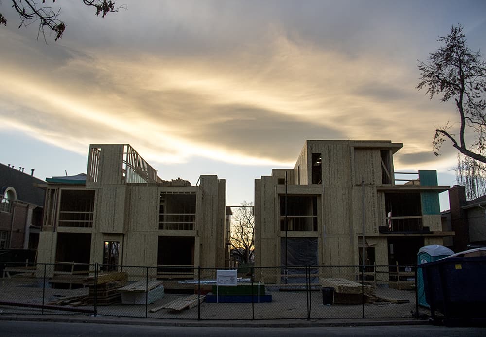 Photo shows new homes under construction in the plywood stage.