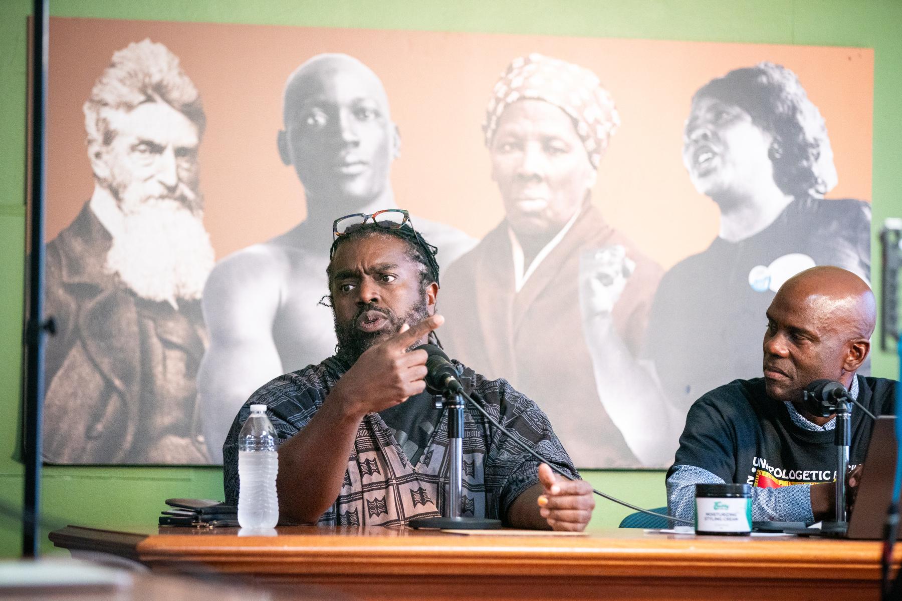 Hashim Coates, left, speaks in support of University of Colorado Regent Wanda James