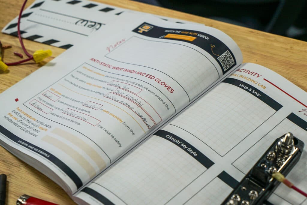 An exercise training book sits open on a workbench