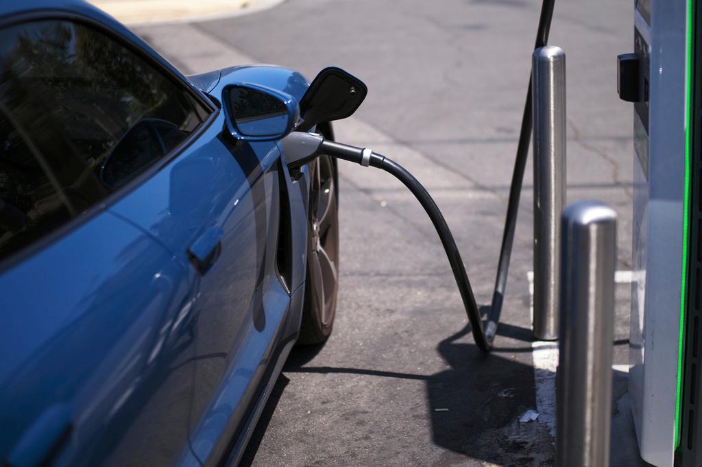 a blue electric vehicle getting charged