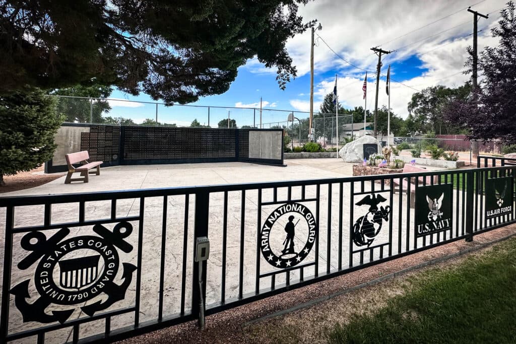 a park with fencing showing different military branches