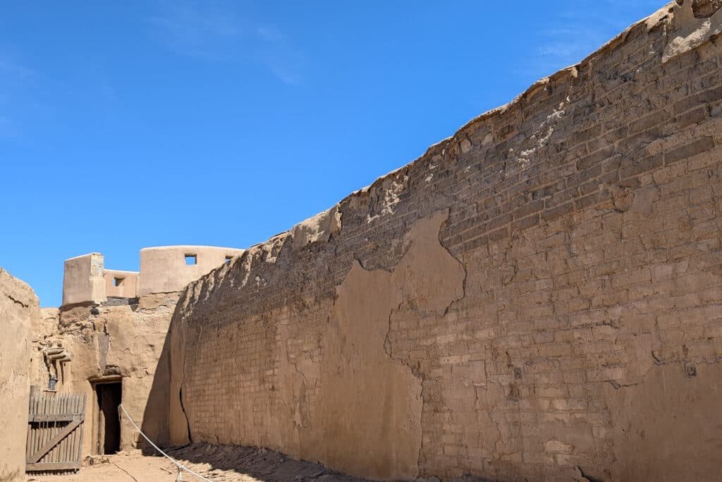 layers of adobe plaster have peeled off adobe brick walls