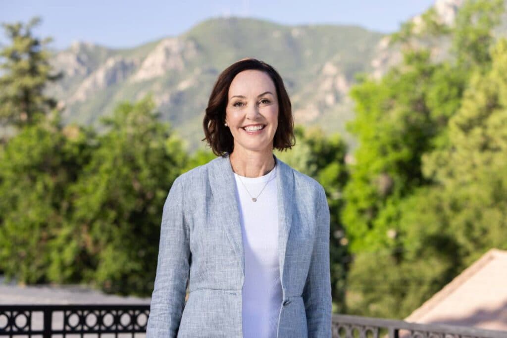 A woman in a grey suit in a pant suit