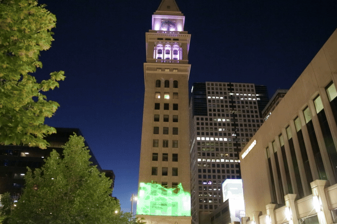 A green zap travels up the clocktower, turning white and zapping all over before receeding back to the bottom of the clock tower, where it starts all over again.