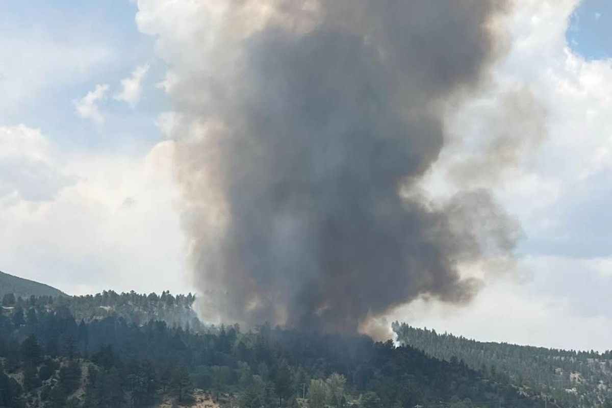 smoke rising from the mountains heavy trees