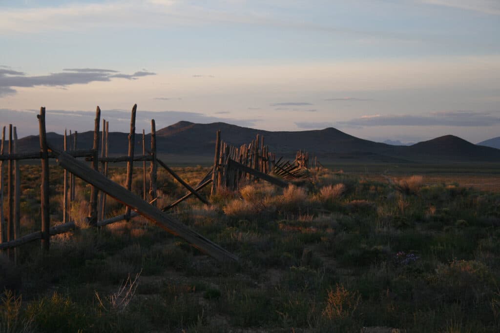 A landscape of the moutains with the grass in the foreground.