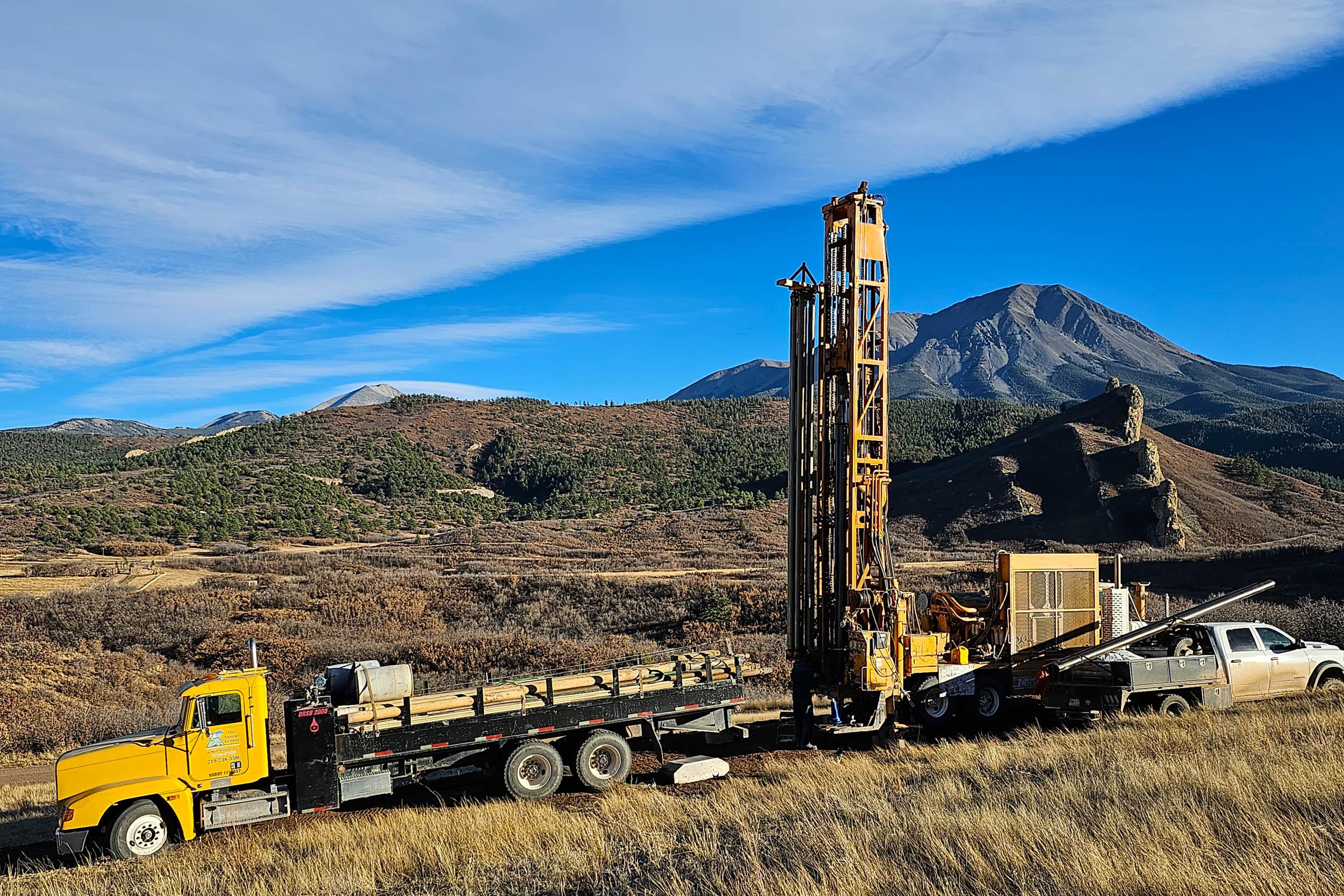 a well drilling rig and truck