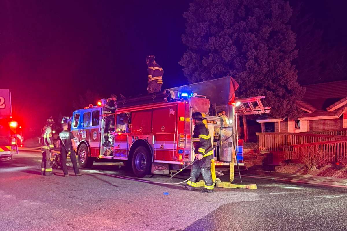 A fire truck and firefighters at the scene of an accident