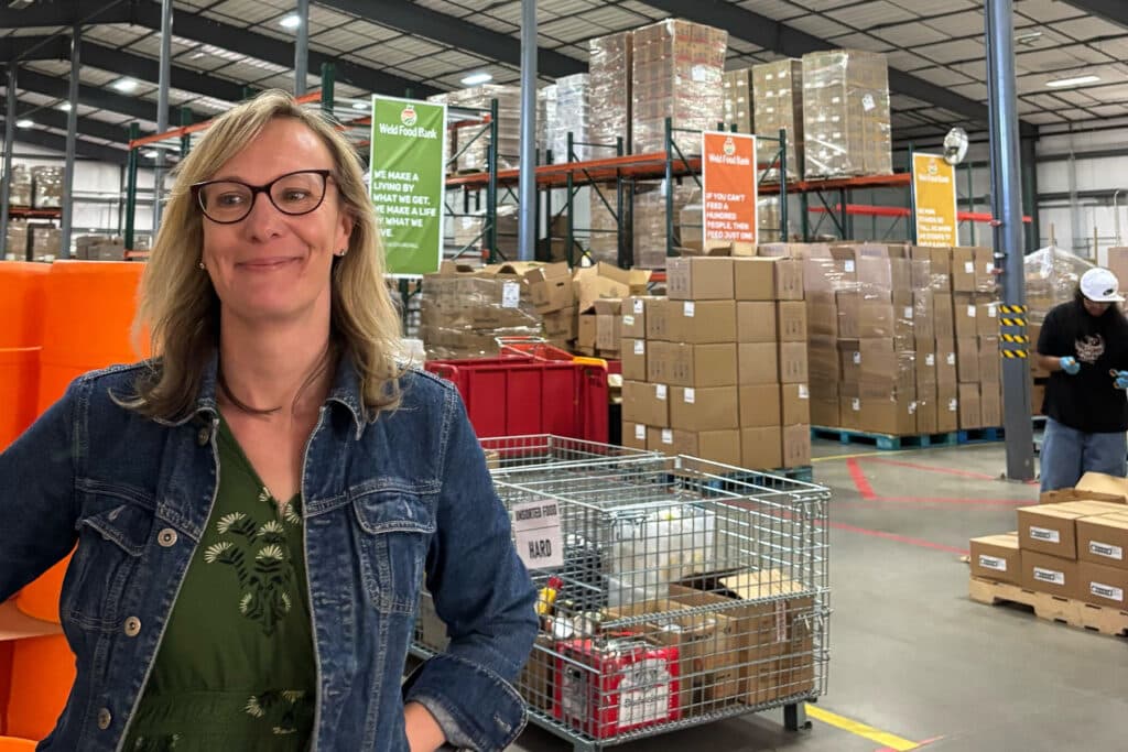 A woman stands in a warehouse