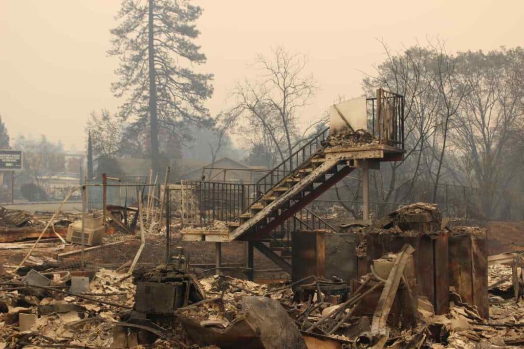 the remains of a burned out structure with only a staircase still standing
