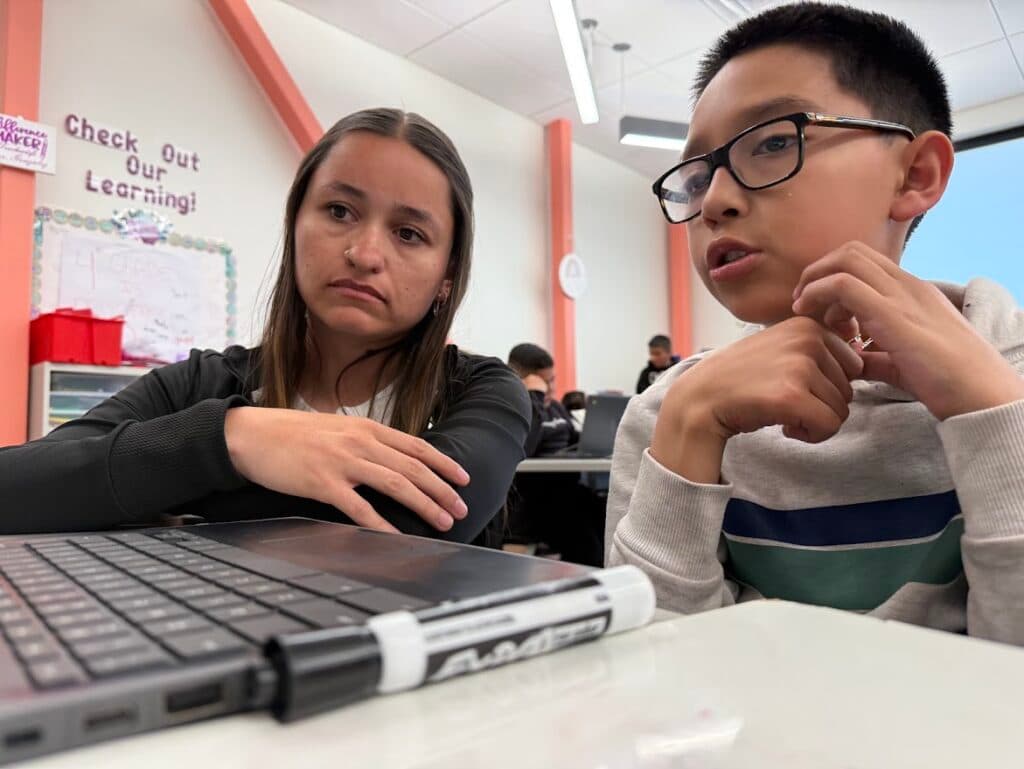 A teacher helps a student