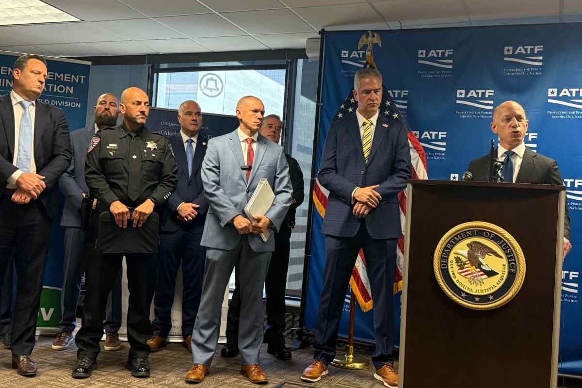A group of men standing at and next to a podium