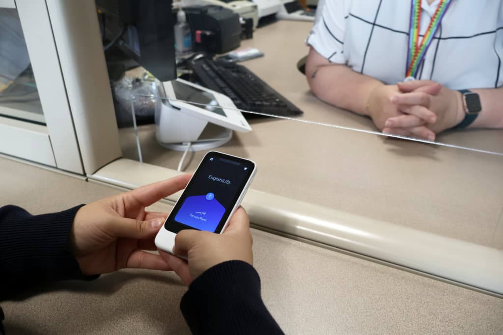 Person using handheld translation device