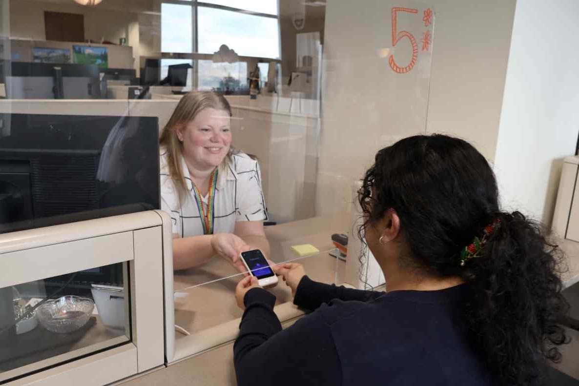 Two staff using handheld translation device
