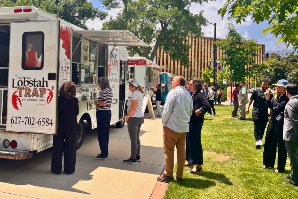 People standing in front of food trucks