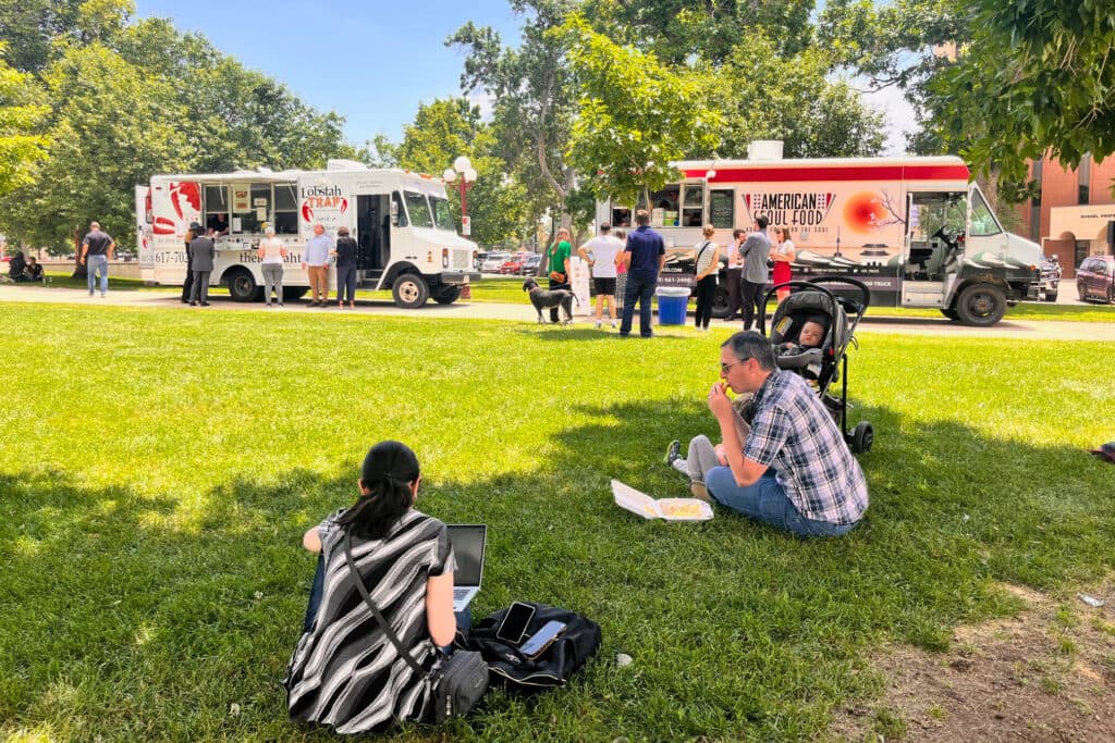 People standing in front of food trucks