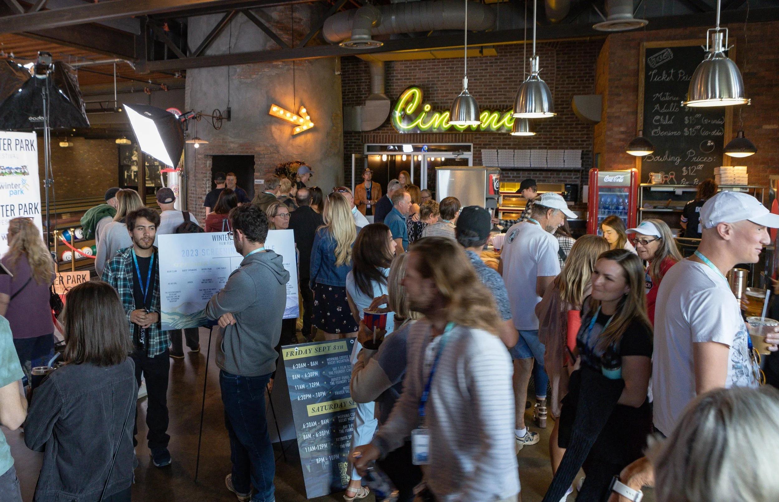 A crowd of people fill the lobby of The Foundry Cinema & Bowl