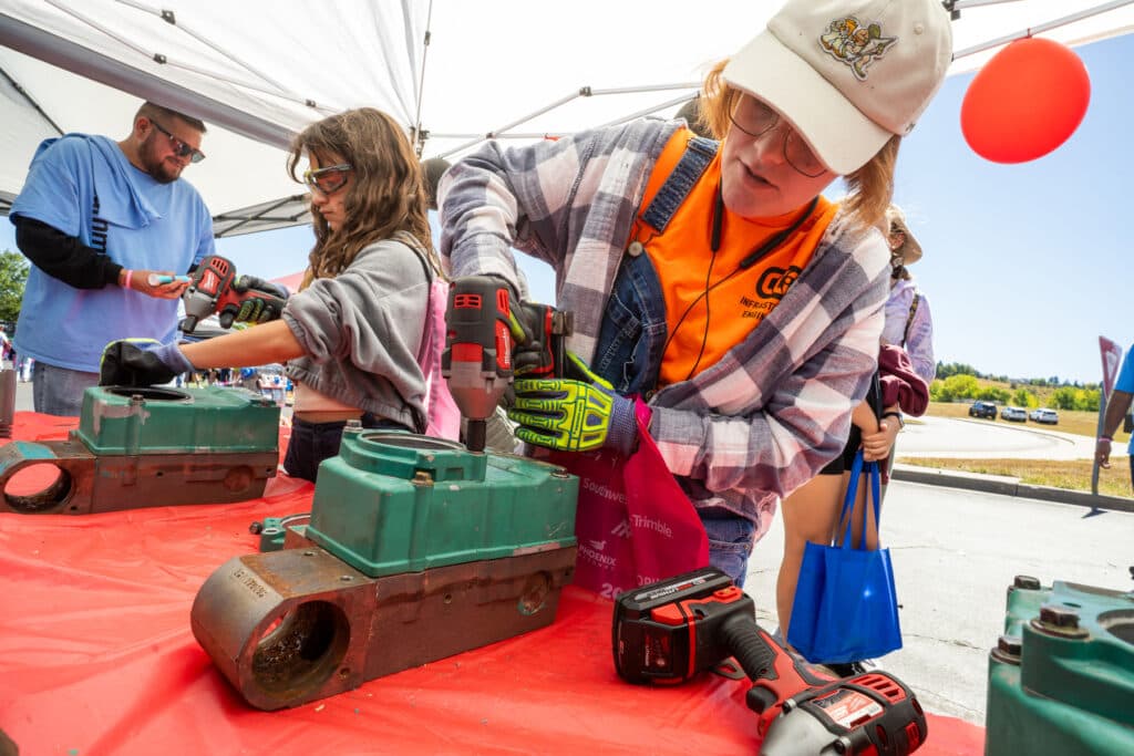 A girl tries her hand with power tools