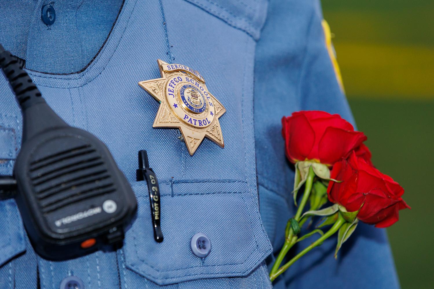 Jefferson County School Patrol members carried roses at a vigil