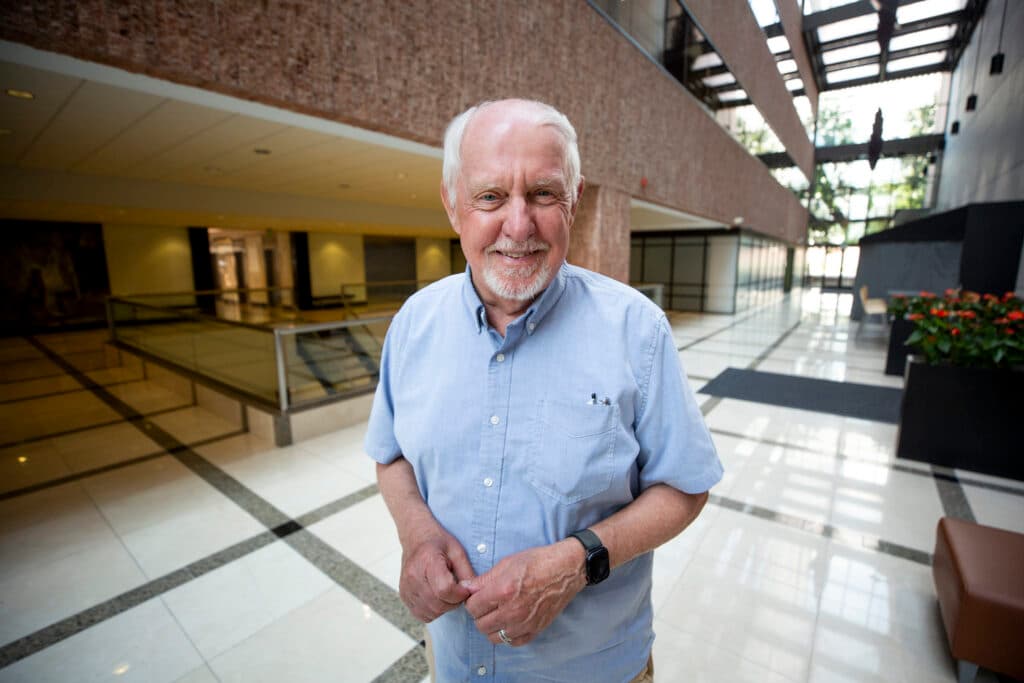 A man stands in an atrium.