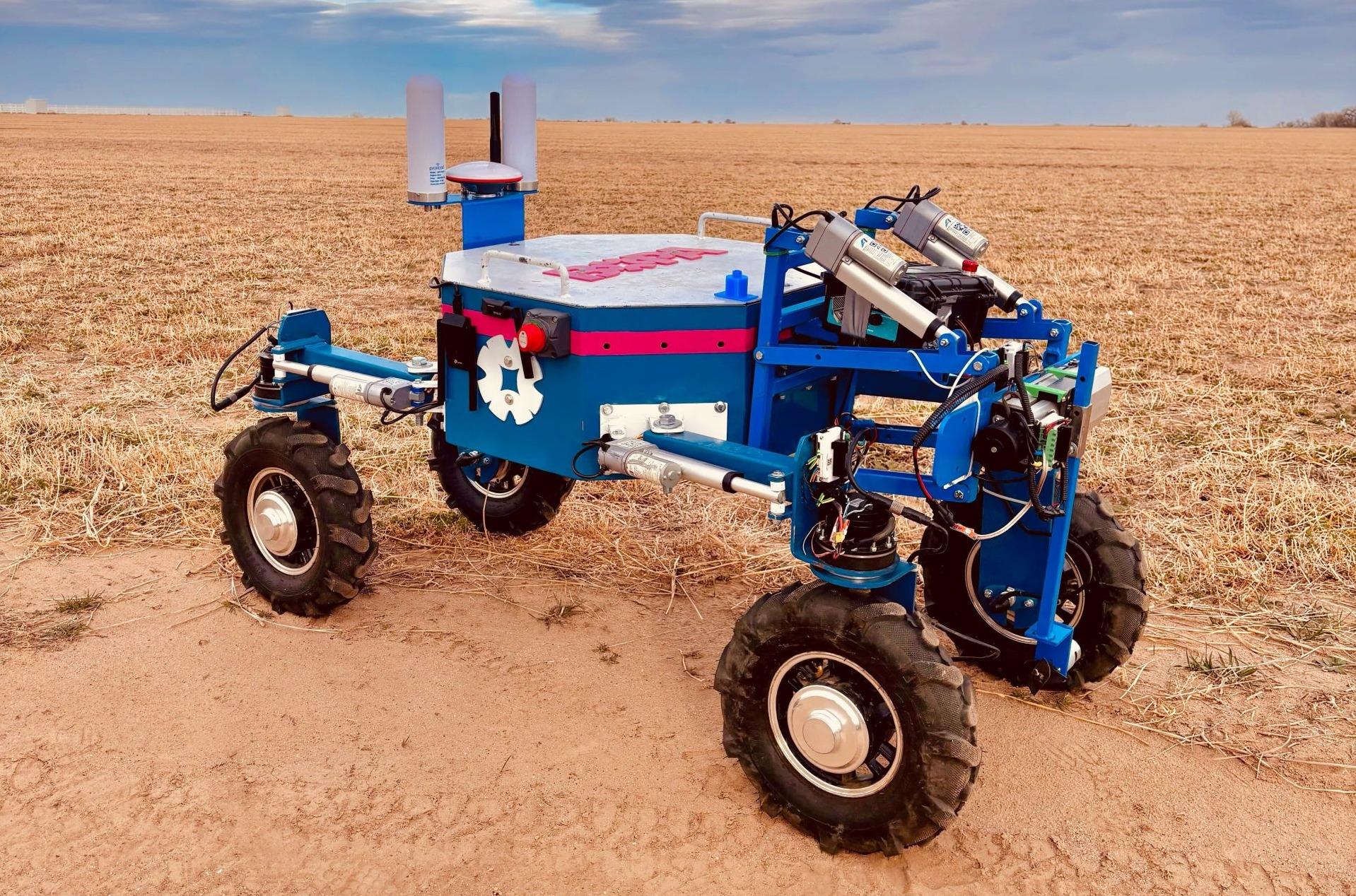 a four wheel robot tractor in a field