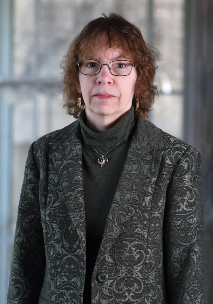 head and shoulders portrait of person looking at camera