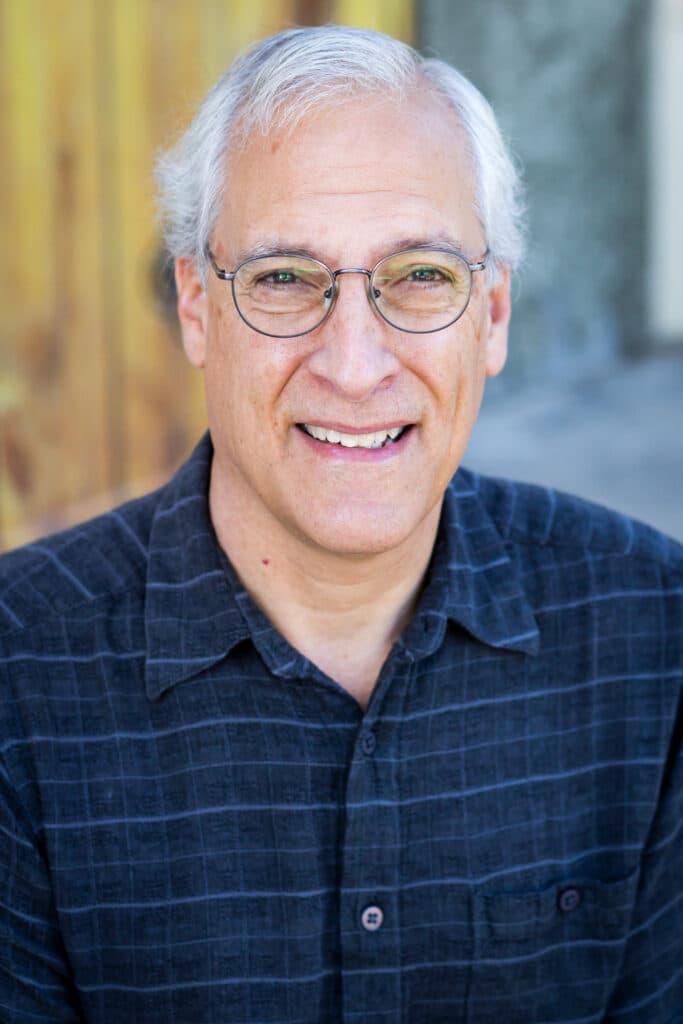 head and shoulders portrait of person looking at camera