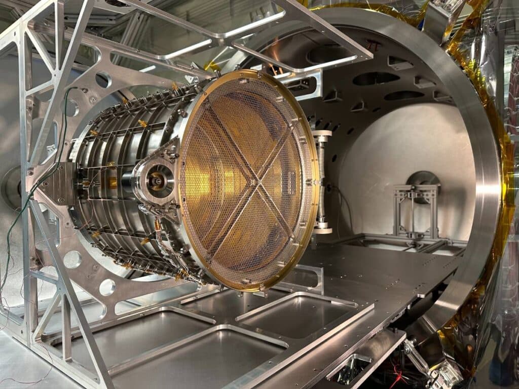 A large metal object with a yellow center is sitting on a silver surface.