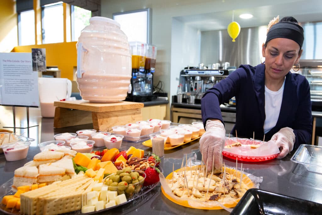 Odila Colato prepares food samples at LatinA Café