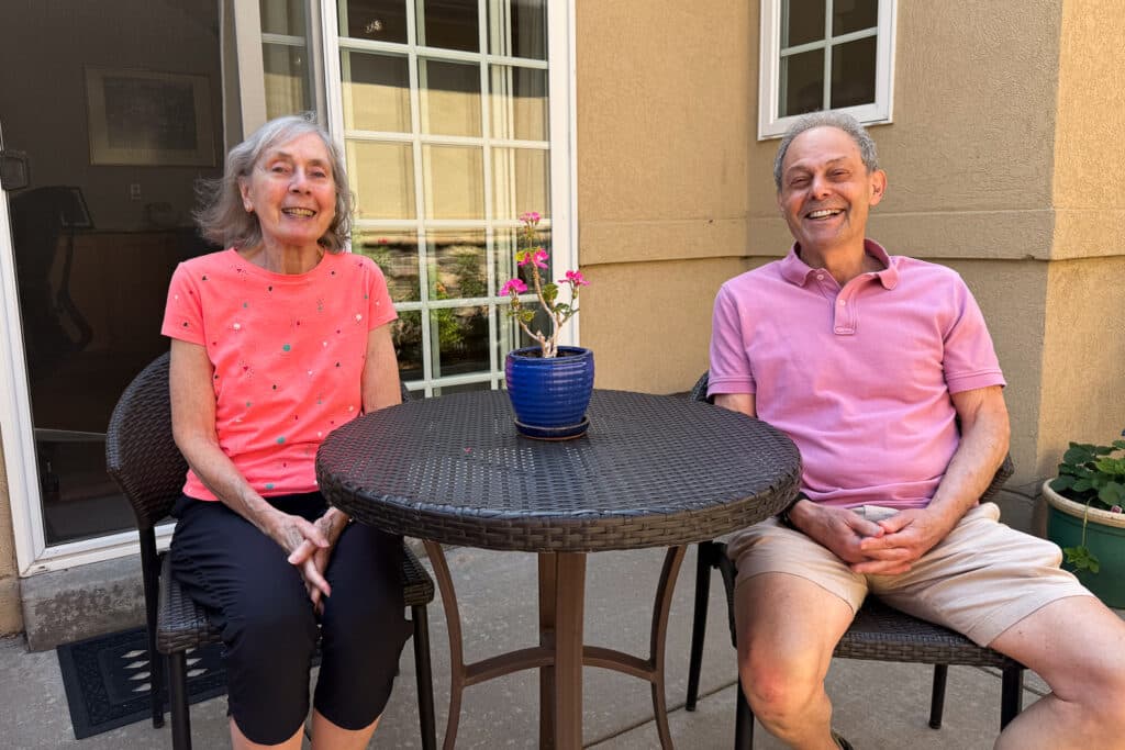 Two older people in their backyard.