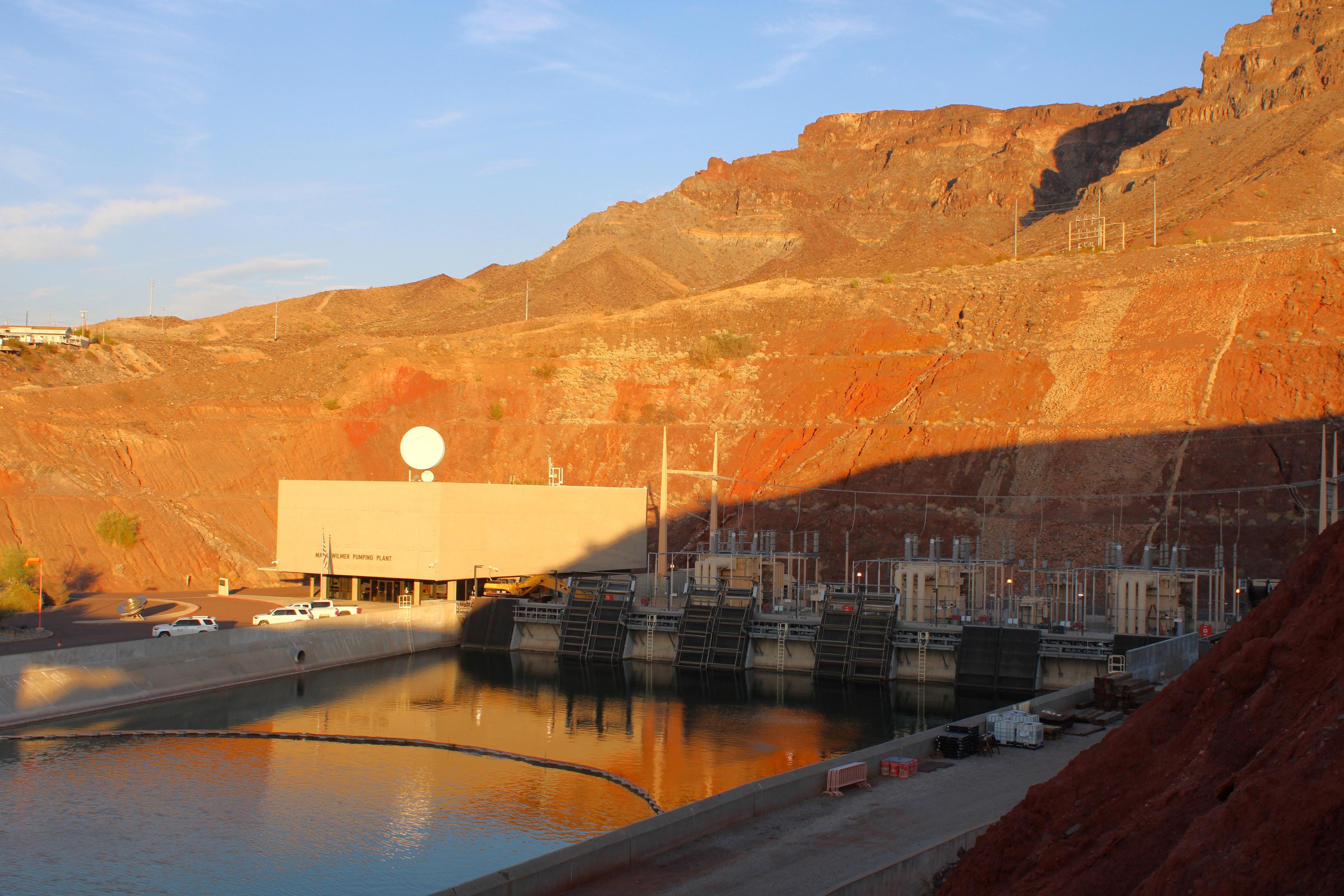 a canal runs into a red rock mountain