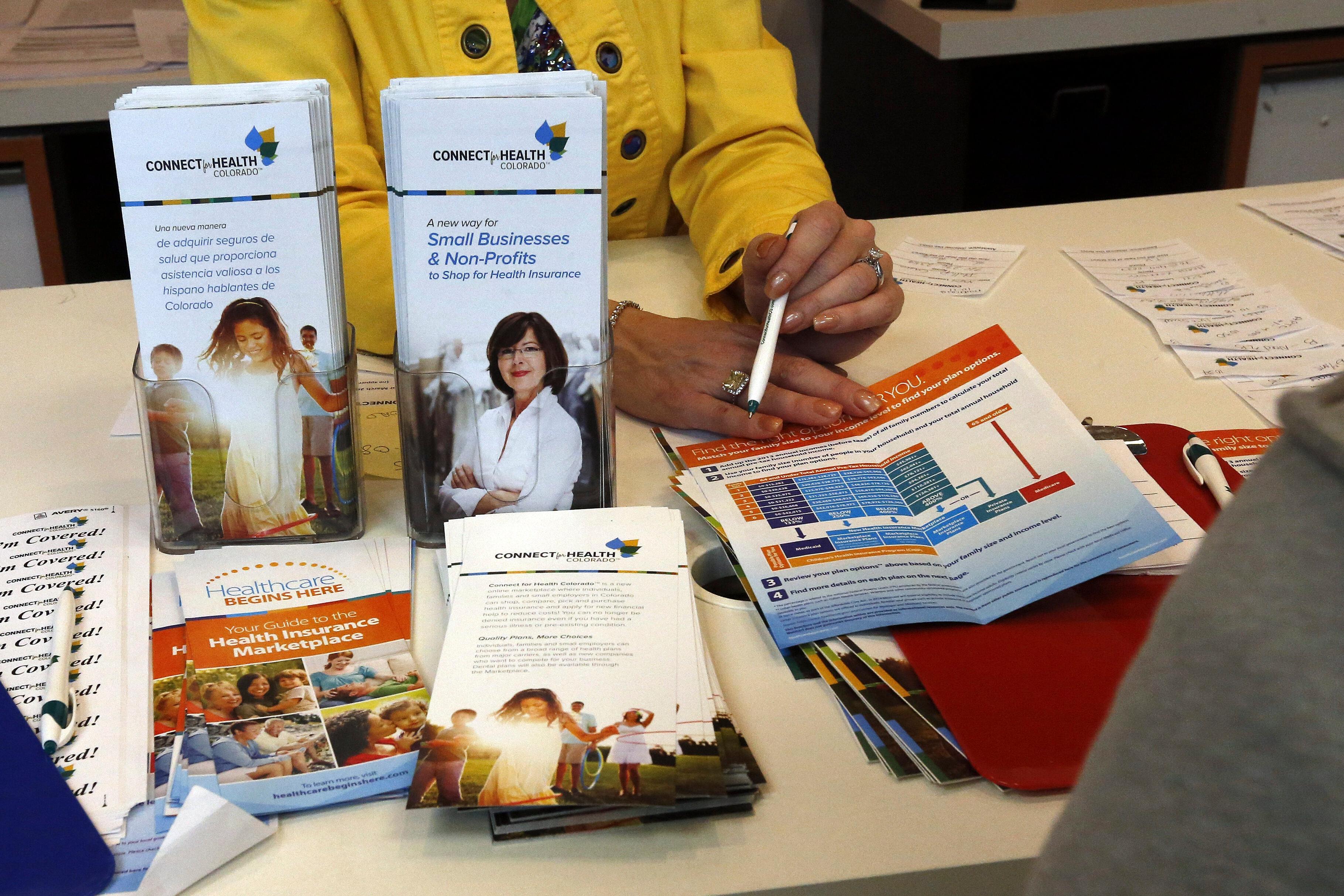 Table with Connect For Health Colorado informational pamphlets.
