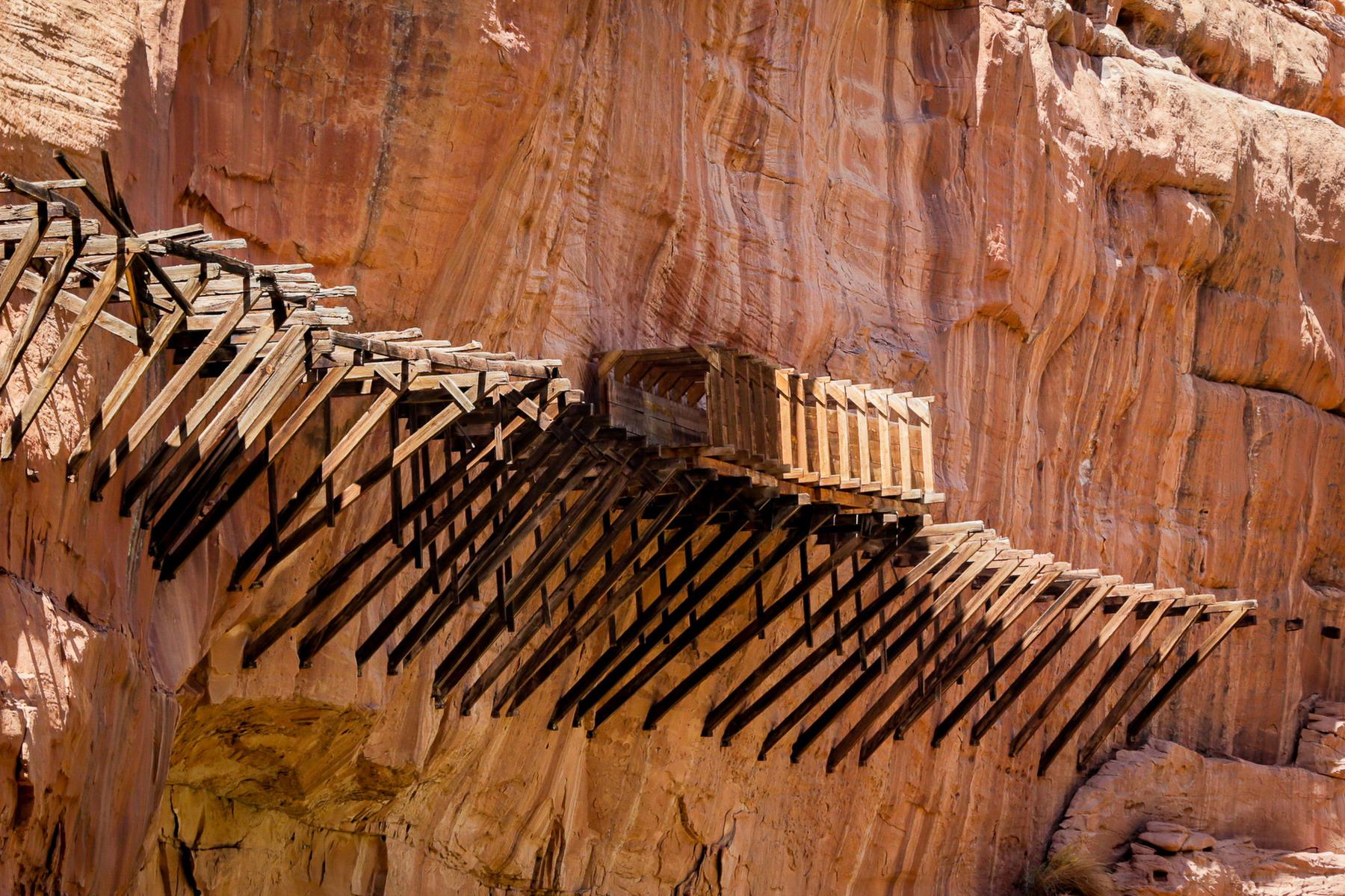 The historic and partially reconstructed flume on a cliff above the Dolores River once carried water to placer gold miner sluices east of Bedrock