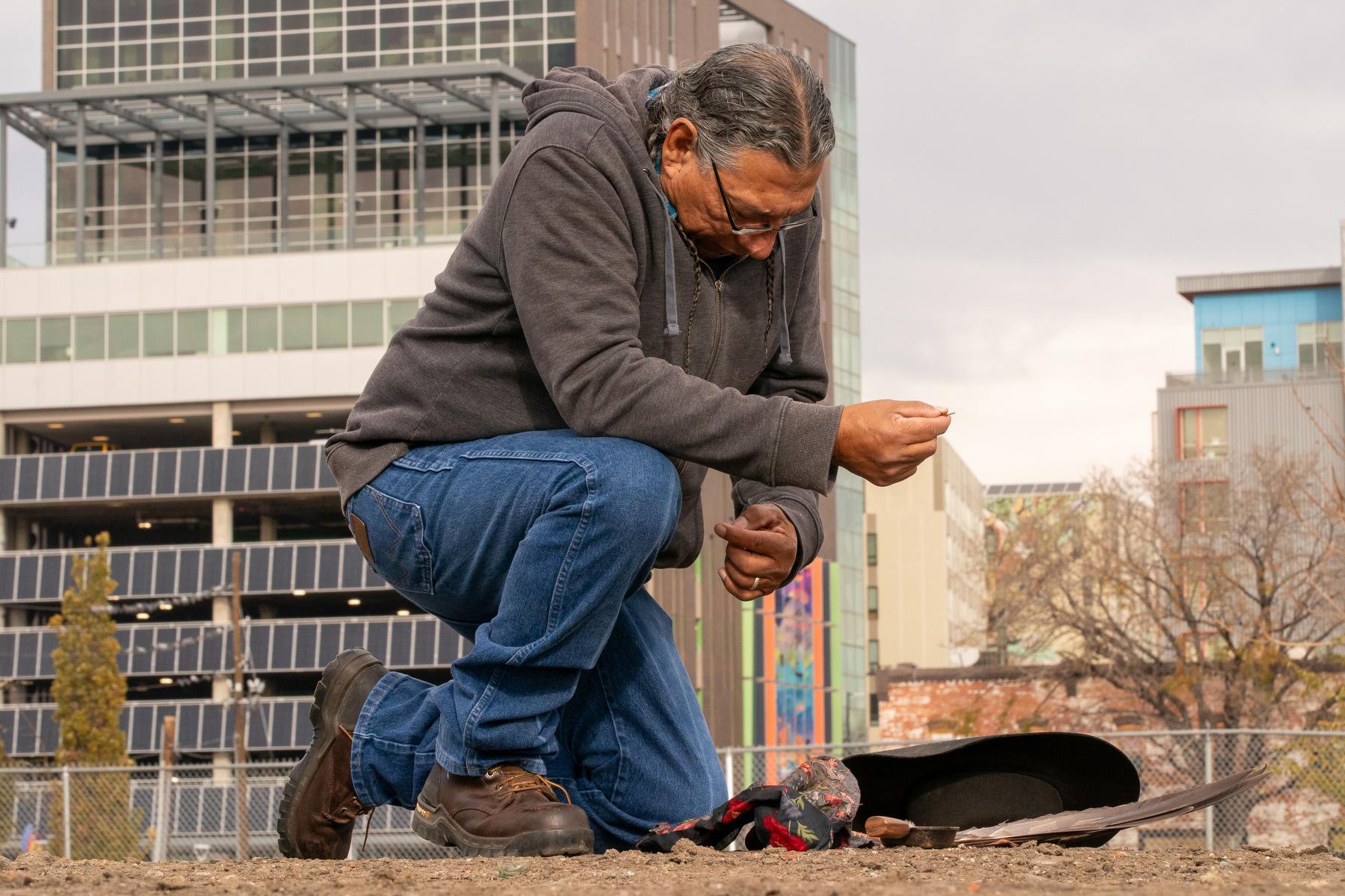 Fred Mosqueda, who works for the Cheyenne-Arapahoe government, performs a land blessing