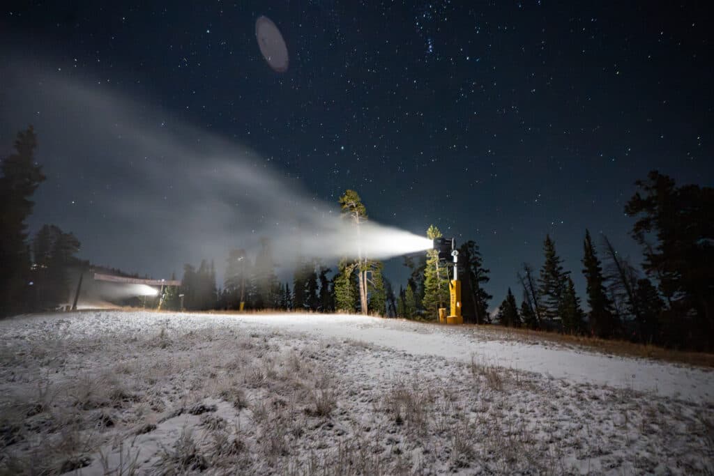 A snowmaking machine sprays snow