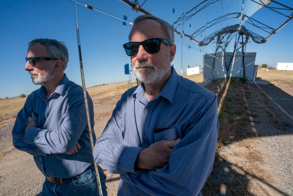 Hank Price of Solar Dynamics reflected in a parabolic solar collector