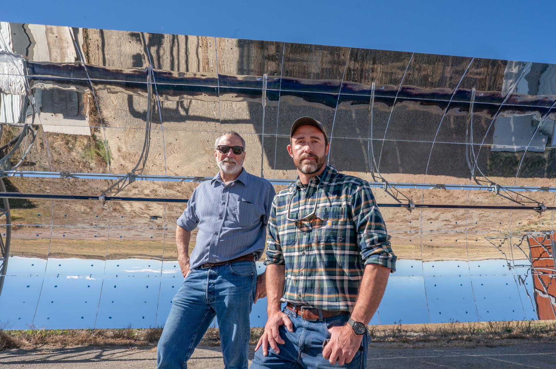 Hank Price, left, and Patrick Marcotte, of Solar Dynamics, in front of the parabolic solar collector they built