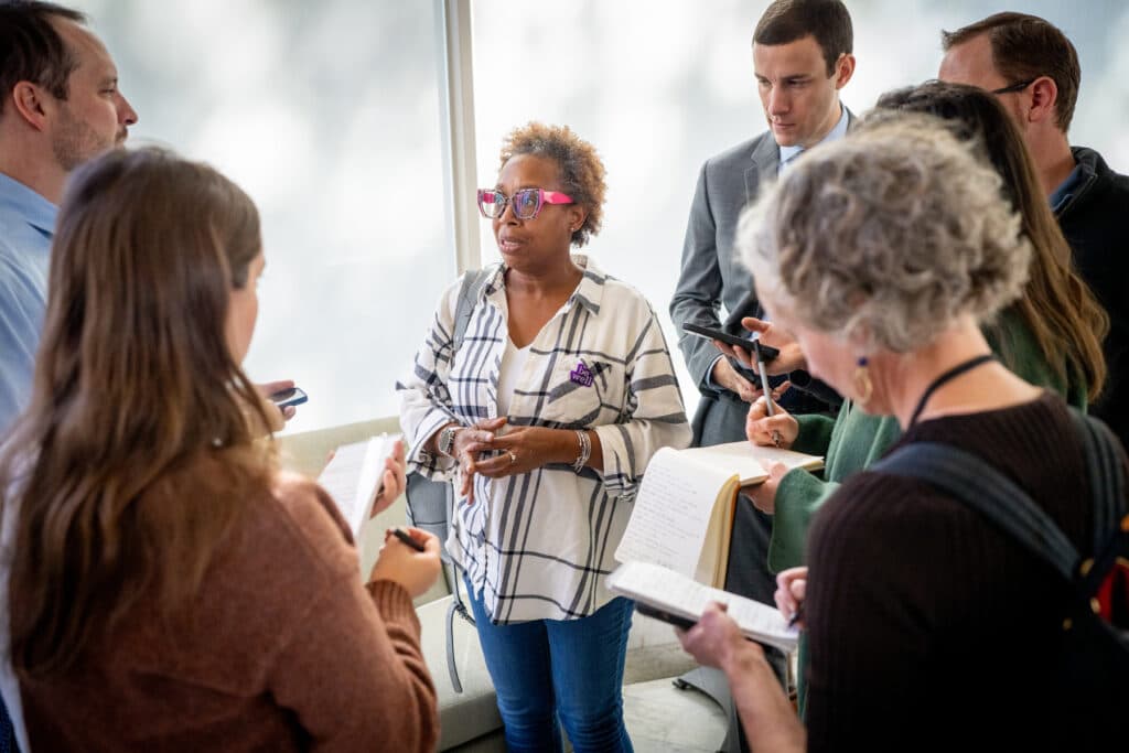 Denver area resident and food assistance recipient Dawn Washington, center, speaks with reporters