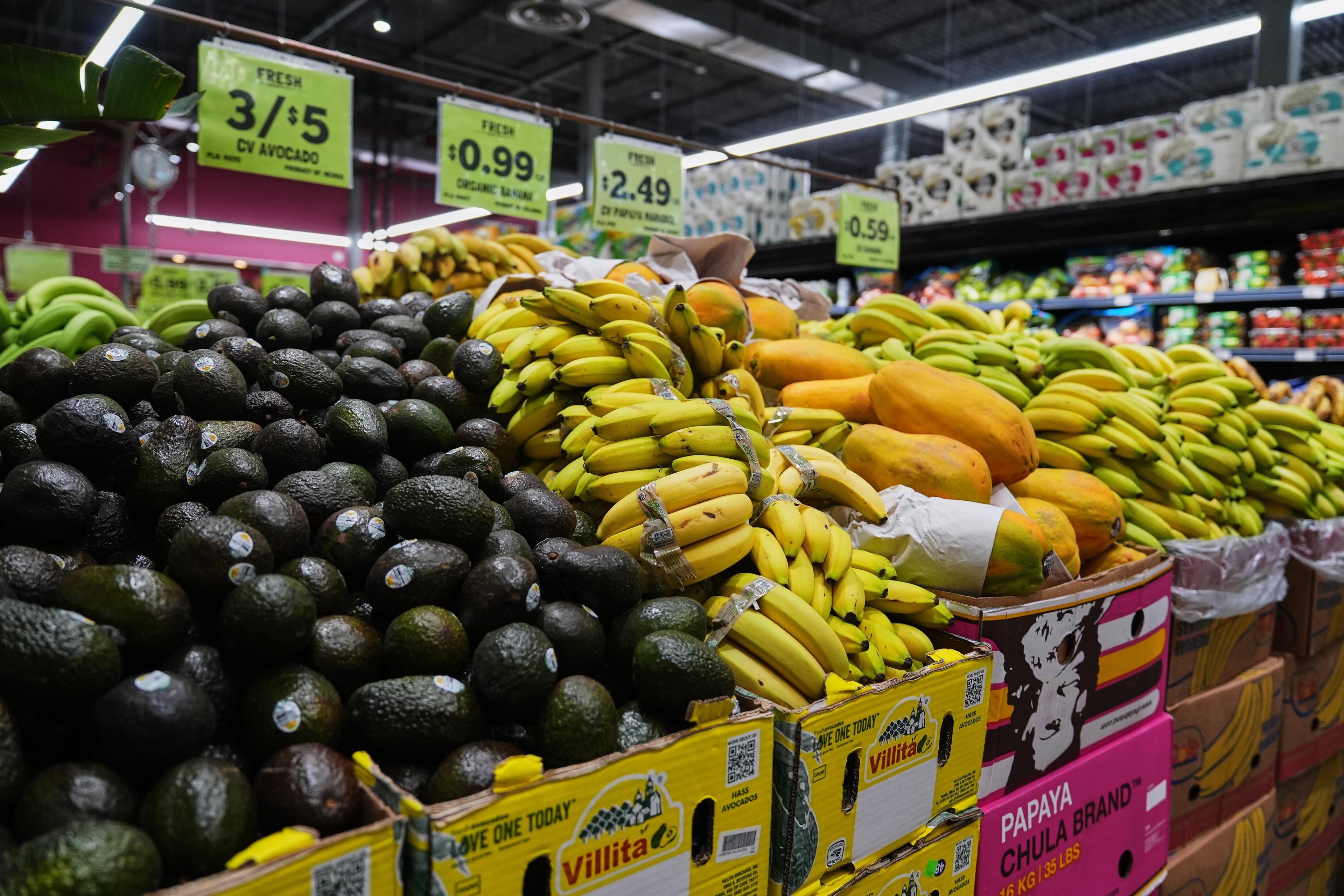 a row of groceries sits in boxes in a grocery store