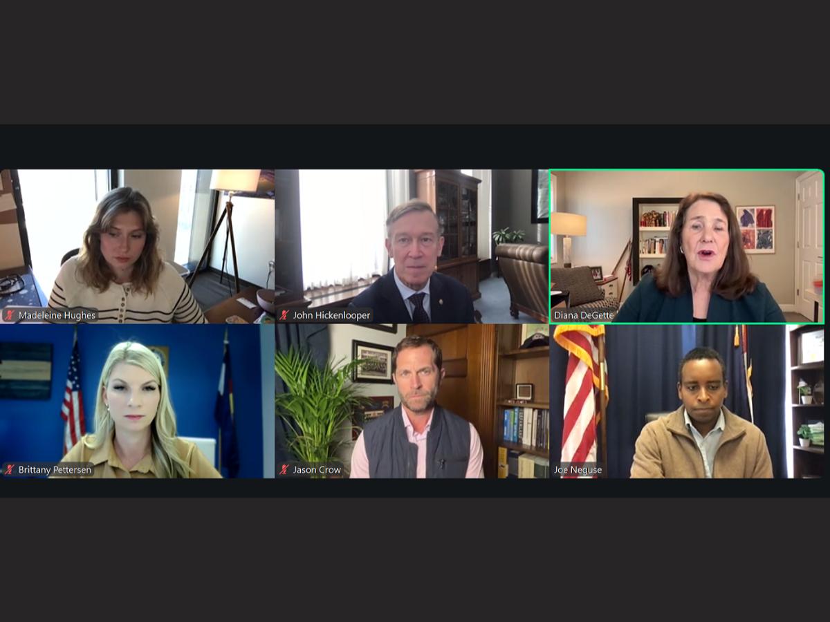 The image displays a group of people on a video call, with each person's face visible on a separate screen.