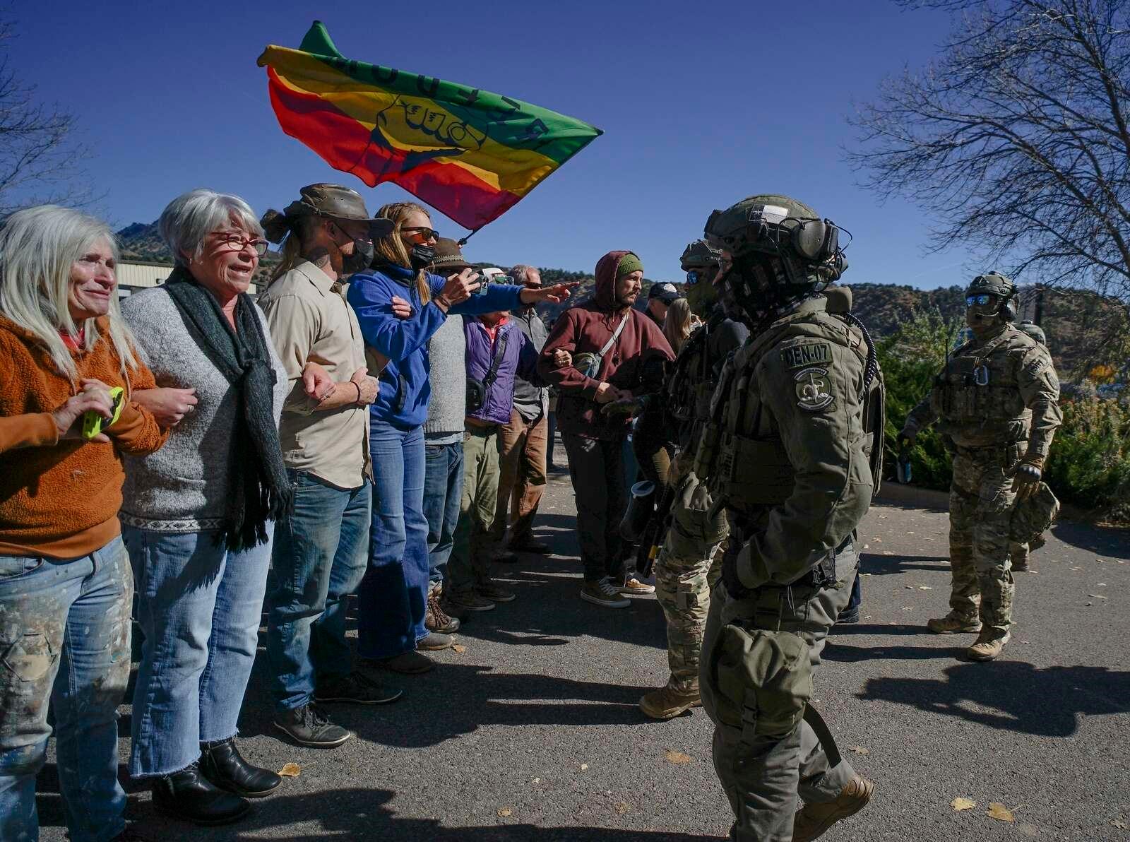 A group of people are gathered together standing in a line.