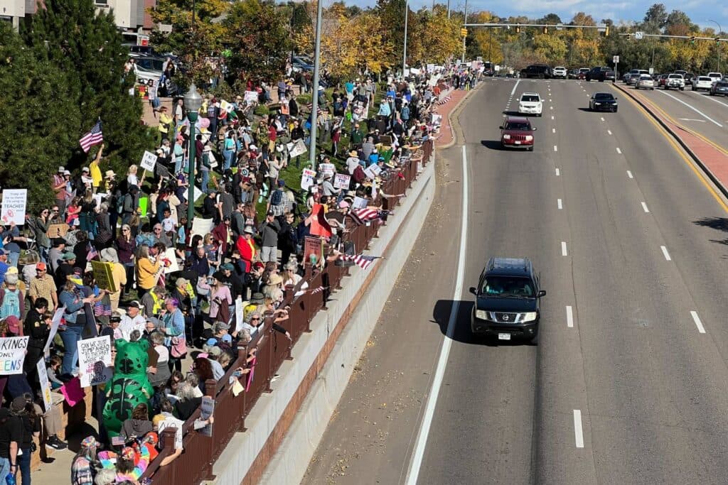 Overlooking a protest to the right of a road from an overpass