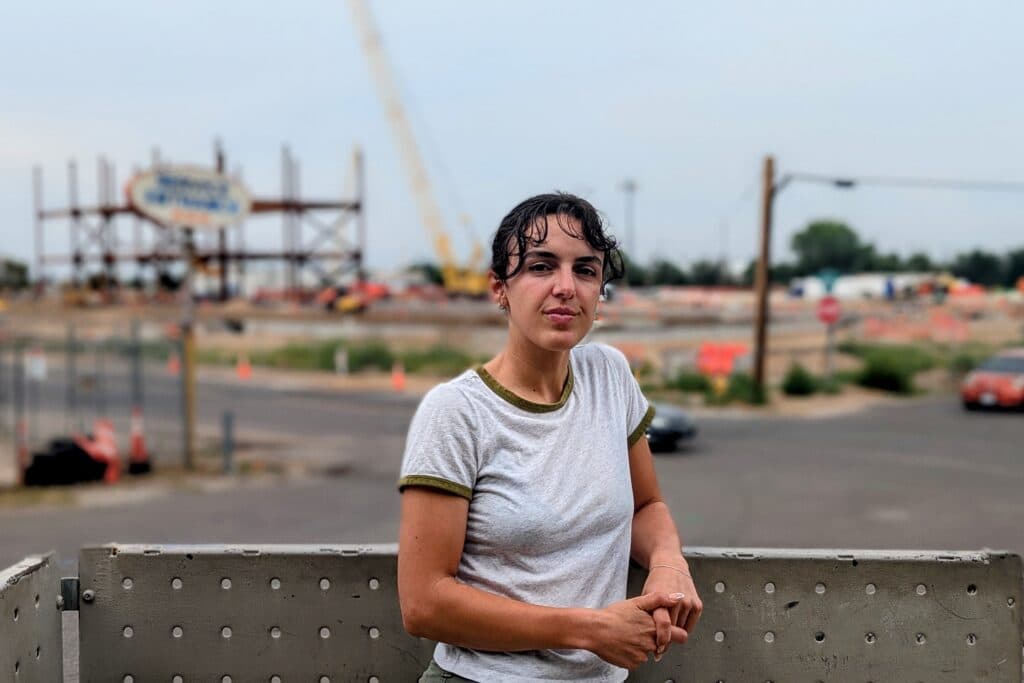 A community activist stands near a data center construction site.