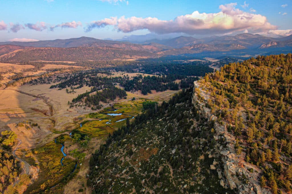 landscape with a mountainous area, a valley, and a river flowing through it