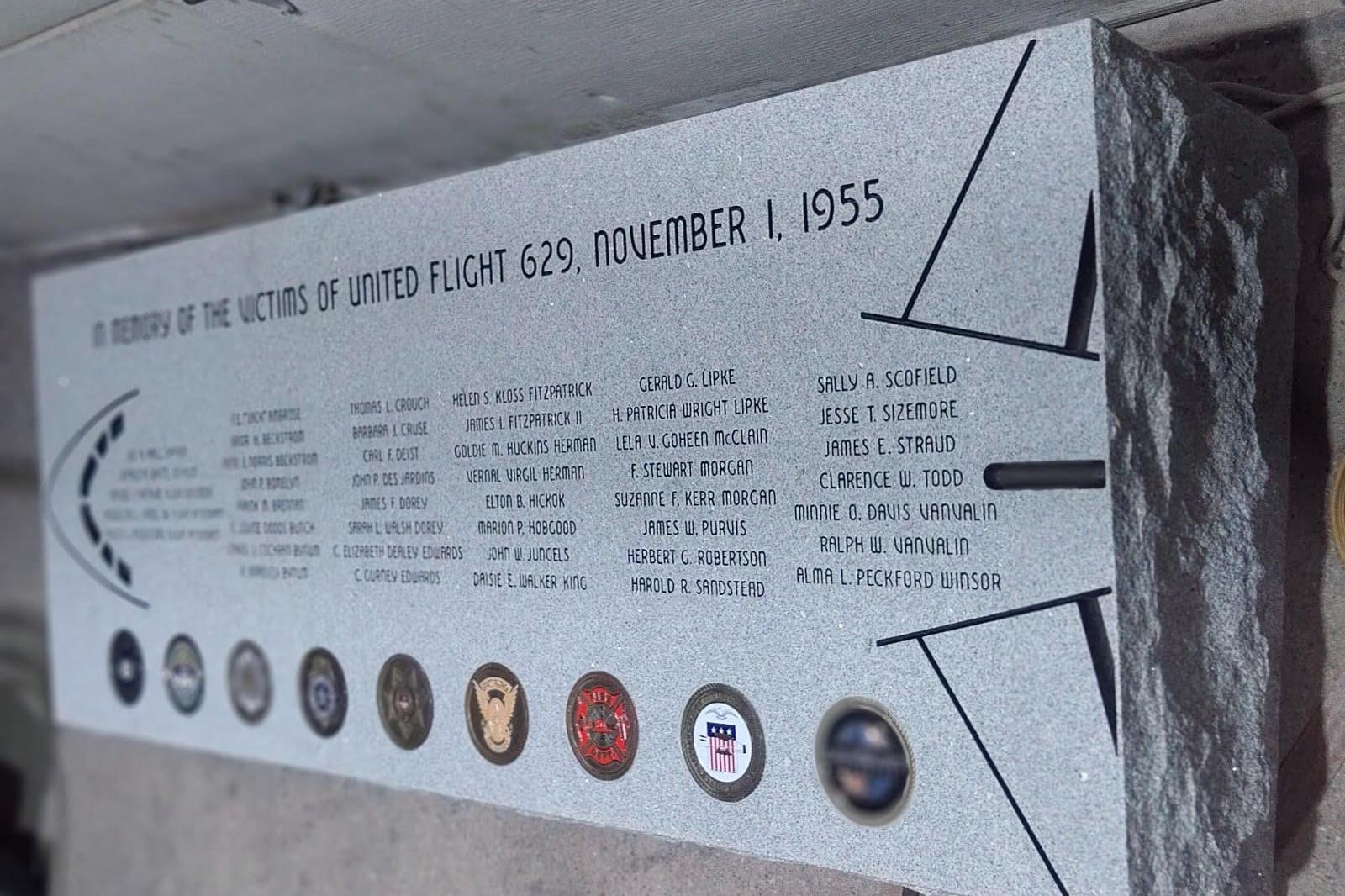 A granite marker lists all 44 people killed in the attack on Flight 629. Seals of agencies that responded to the disaster are also featured beneath an outline of an airplane.