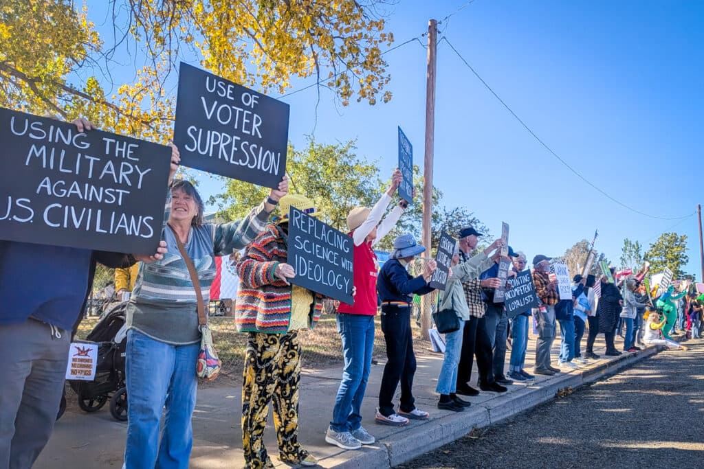 A group of people holding signs and protesting