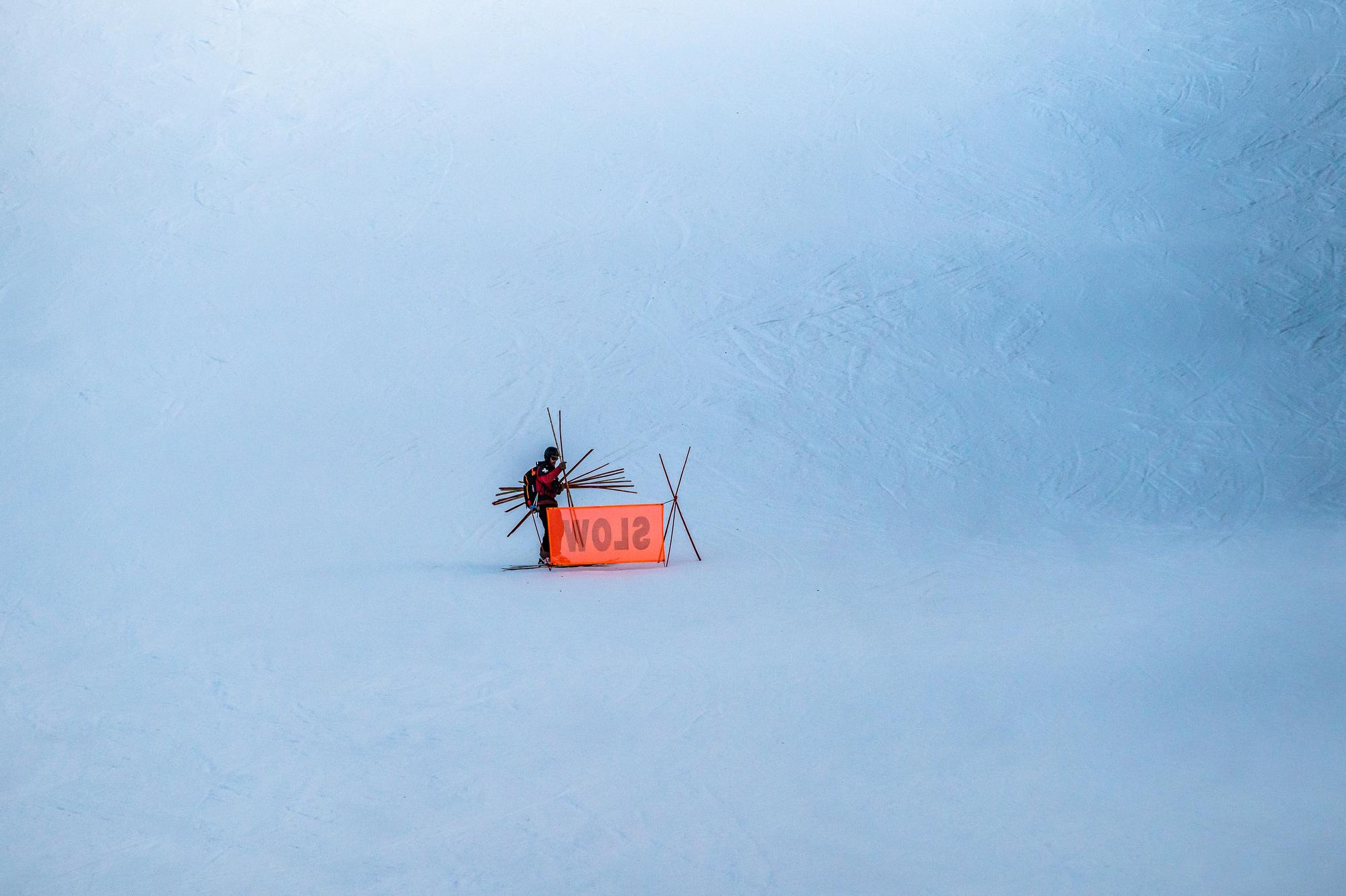 Ski patrol at Arapahoe Basin picking up signs at the end of the day
