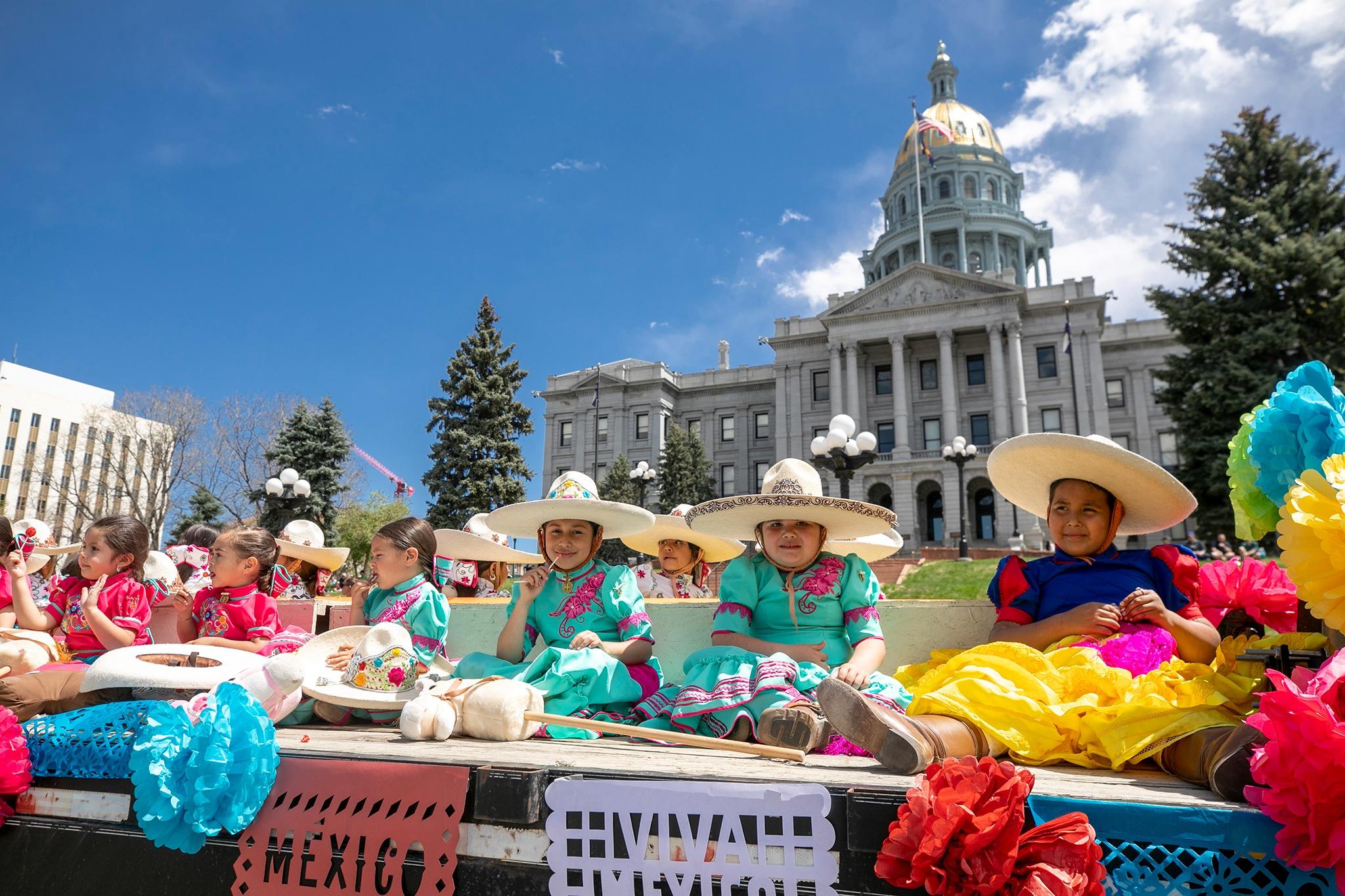 Costumed kids on a parade float in front of the Colorado Capitol