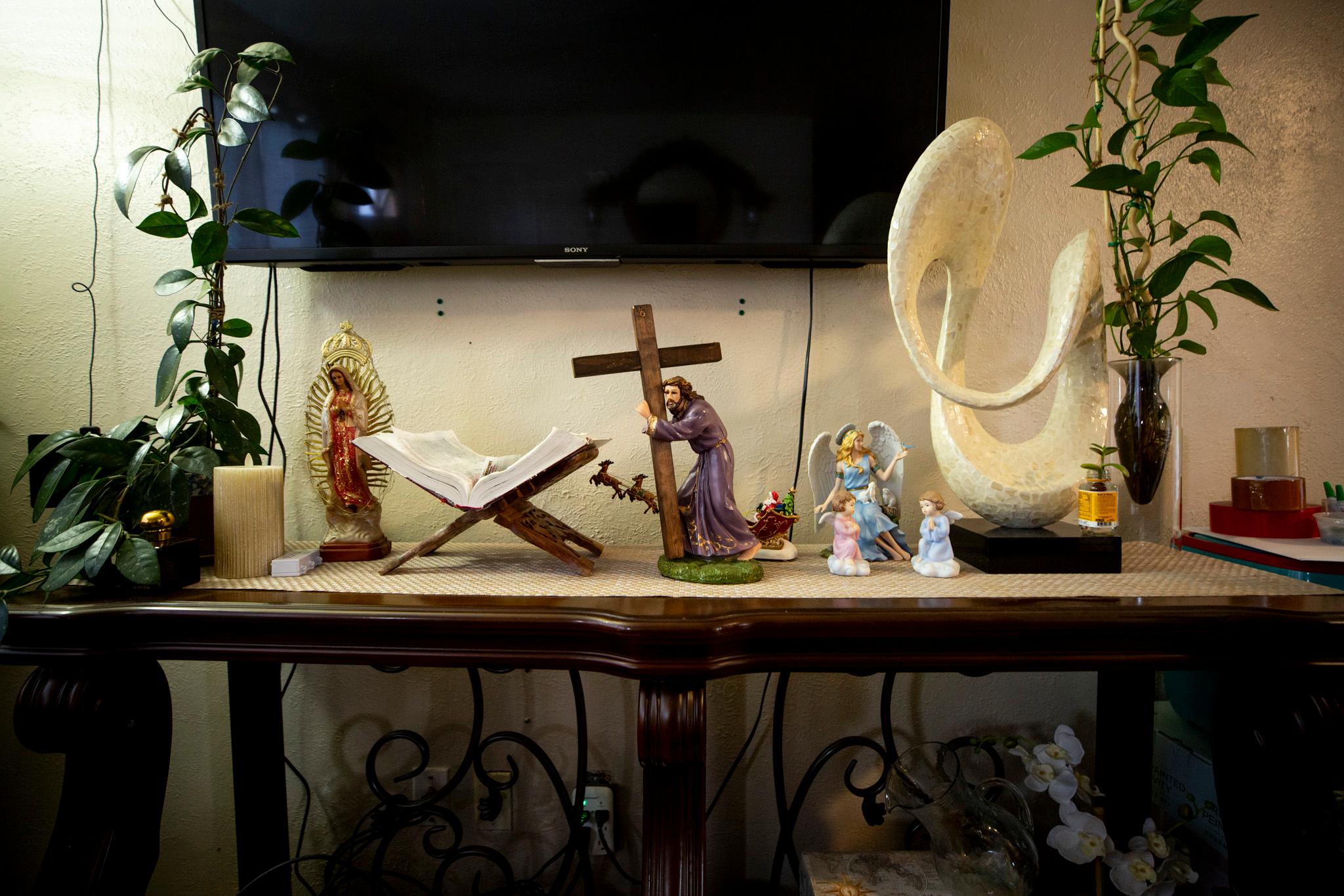 Religious figurines cover a table in Blanca&#039;s Westminster home. Nov. 20, 2025.