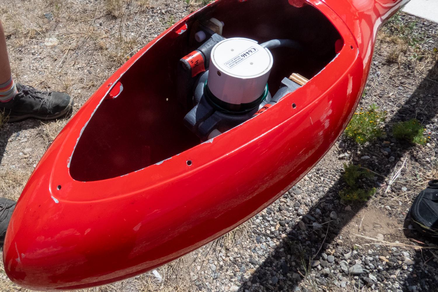 a scientific instrument sits inside a red enclosure that has the lid removed